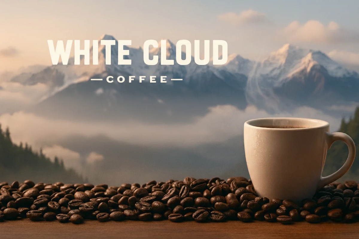 White Cloud Coffee mug and roasted beans against snowy mountain backdrop